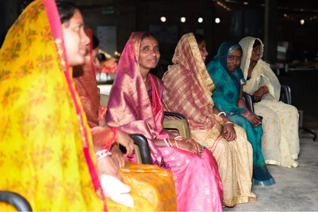 Members of the FPO, including Sanju Devi in pink, meet in Bisfi at the headquarters of their FPO.