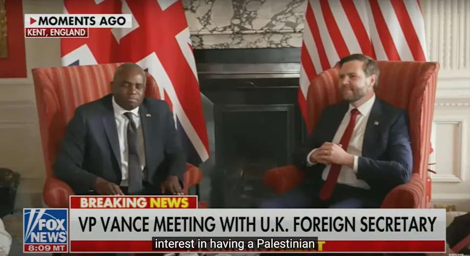 Two politicians seated, engaged in discussion. U.K. flag in the background. News banner reads, "VP Vance meeting with U.K. Foreign Secretary."