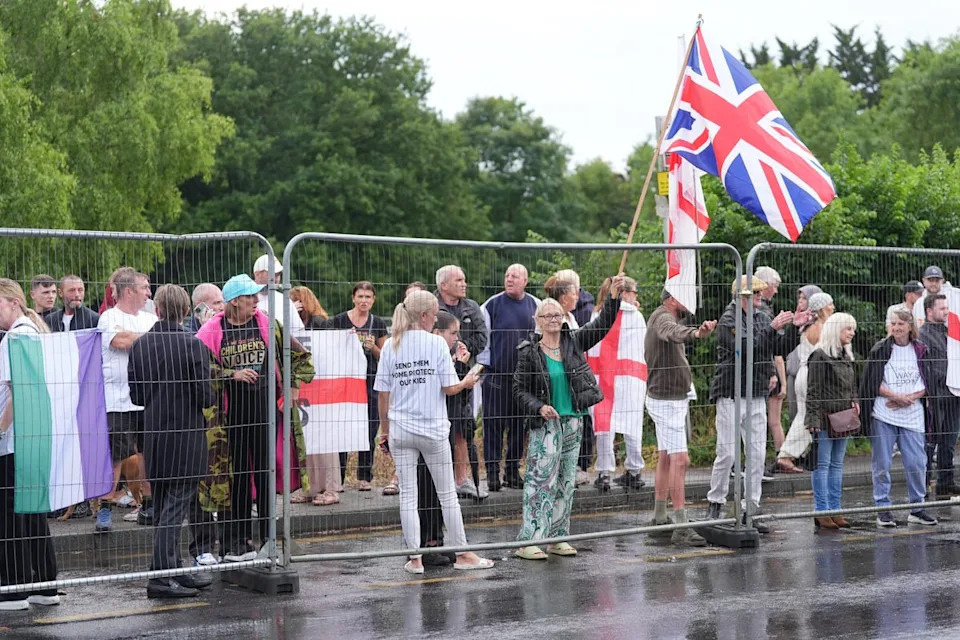 Demonstrators outside The Bell Hotel in Epping (PA Wire)