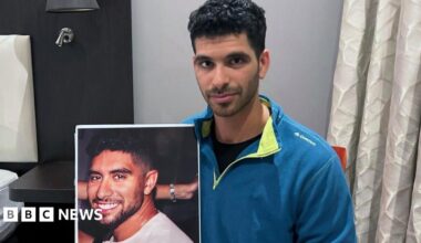 Ilay David holds a poster of his brother Evyatar David. Photo: November 2023