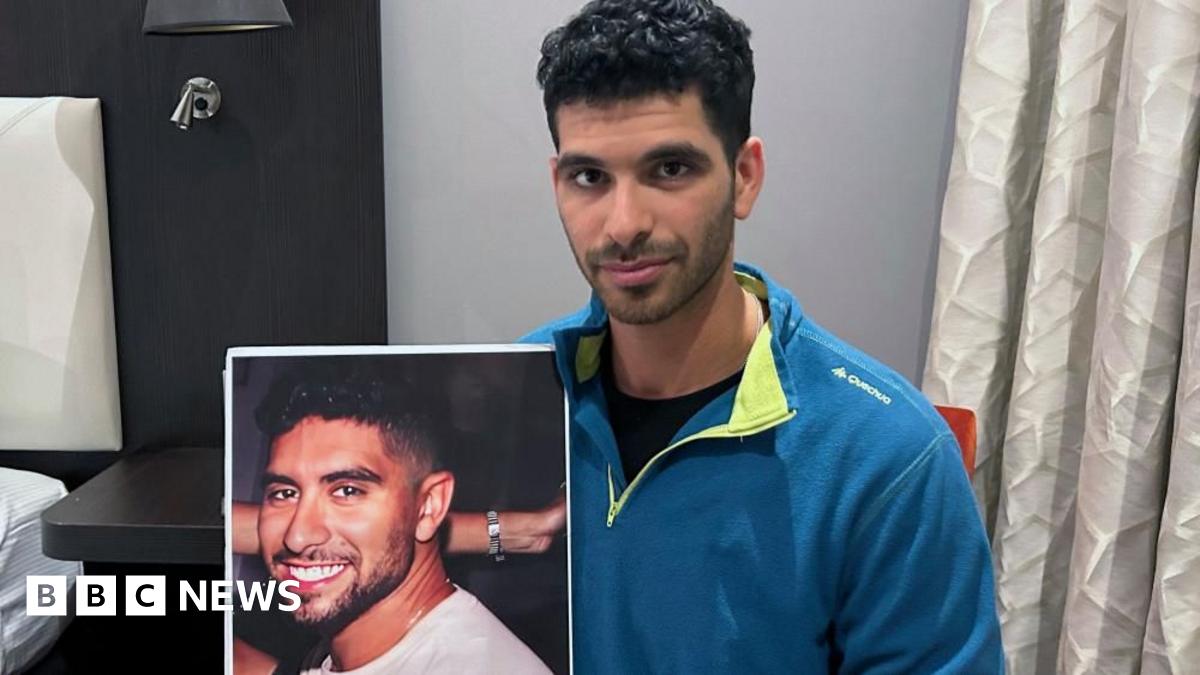 Ilay David holds a poster of his brother Evyatar David. Photo: November 2023