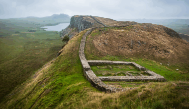 a series of small walls in a lush, mountainous landscape