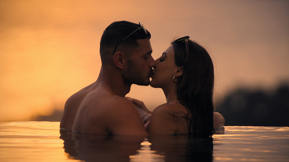 Kal and Sarover kissing in the pool.