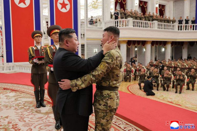 This undated picture released from North Korea's official Korean Central News Agency (KCNA) on August 22, 2025 shows North Korean leader Kim Jong Un (L) embracing a serviceman as he attends a ceremony to award state commendations to the commander and combatants of the Korean People's Army's Overseas Operational Forces, who took part in military operations in Kursk Oblast to help Russia in its war against Ukraine, at the headquarters building of the Central Committee of the The Workers' Party of Korea (WPK) in Pyongyang. (Photo by KCNA VIA KNS / AFP) / South Korea OUT / SOUTH KOREA OUT / SOUTH KOREA OUT / ---EDITORS NOTE--- RESTRICTED TO EDITORIAL USE - MANDATORY CREDIT "AFP PHOTO/KCNA VIA KNS" - NO MARKETING NO ADVERTISING CAMPAIGNS - DISTRIBUTED AS A SERVICE TO CLIENTS / THIS PICTURE WAS MADE AVAILABLE BY A THIRD PARTY. AFP CAN NOT INDEPENDENTLY VERIFY THE AUTHENTICITY, LOCATION, DATE AND CONTENT OF THIS IMAGE --- /