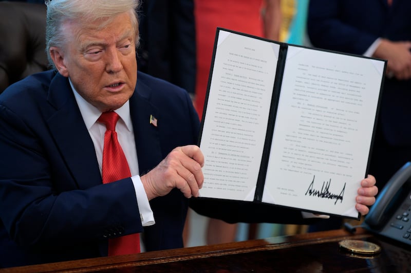 President Donald Trump signs executive orders in the Oval Office at the White House on August 25, 2025 in Washington, DC.
