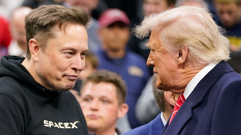 Tesla CEO Elon Musk greets U.S. President Donald Trump as they attend the NCAA men's wrestling championships in Philadelphia, Pennsylvania, U.S., March 22, 2025. REUTERS/Nathan Howard