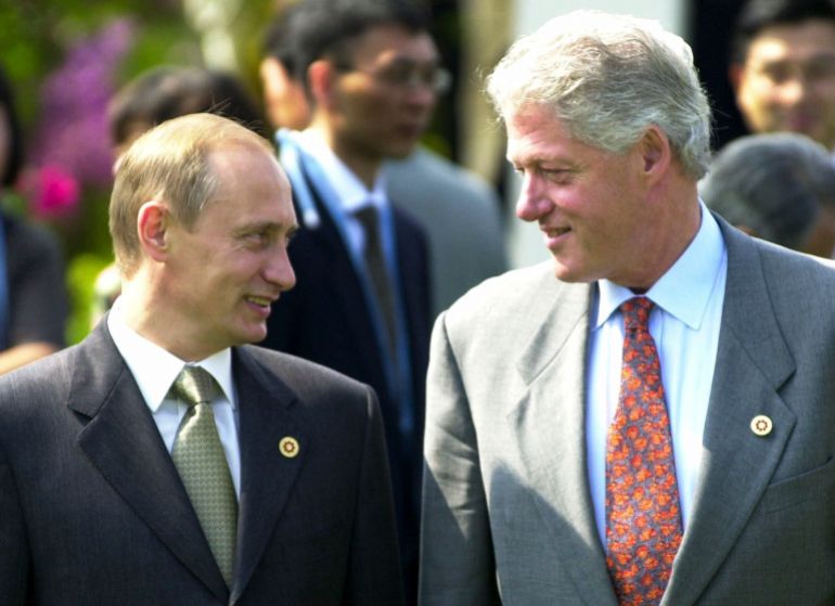 FILE In this Saturday, July 21, 2000 file photo President Bill Clinton shares a light moment with Russian President Vladimir Putin during a tree-planting ceremony at Bankokushinryokan or "bridge to the world," before the Group of Eight meeting in Nago, Okinawa, Japan. (AP Photo/Vincent Yu, File)