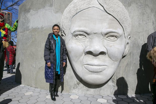 Architect Nina Cooke John stands with the Harriet Tubman monument she designed titled 'Shadow of a Face' in Newark, New Jersey.