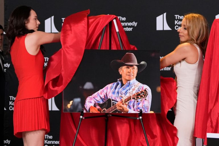Presenters unveil a portrait of George Strait at the Kennedy Center.