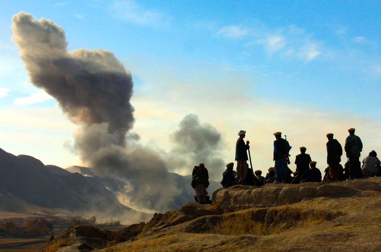 FILE - In this Nov. 19, 2001 file photo, Northern Alliance soldiers watch as U.S. air strikes attac...