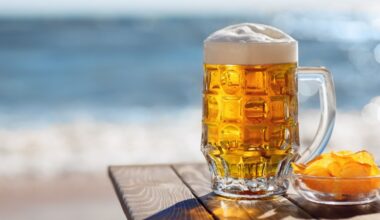 Cold pint of beer on a summery background.