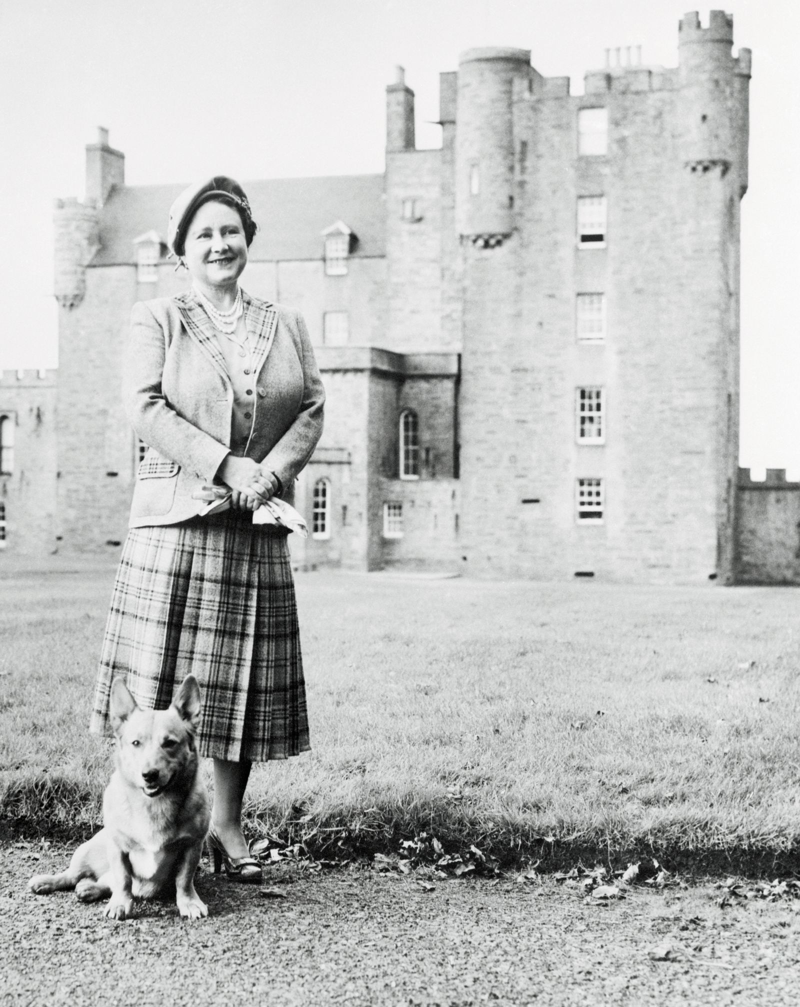 Image may contain Queen Elizabeth The Queen Mother Clothing Skirt Person Adult Animal Canine Dog Mammal and Pet