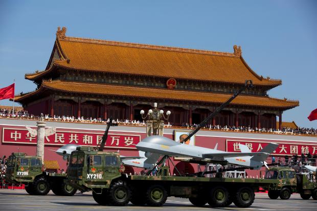 FILE – Military vehicles carrying Wing Loong, a Chinese made...