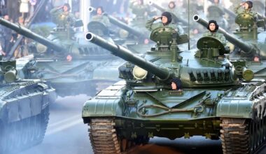 Croatian soldiers salute on top of armored vehicles during a parade in Zagreb