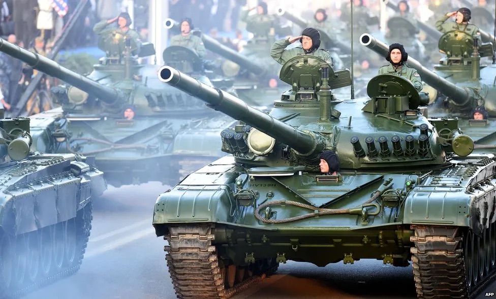 Croatian soldiers salute on top of armored vehicles during a parade in Zagreb