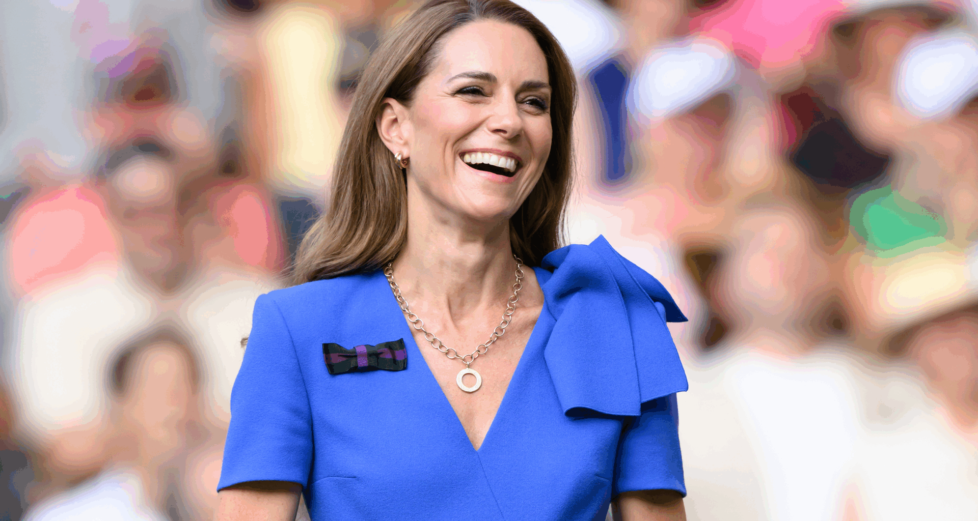 Kate Middleton laughing and wearing a blue dress at Wimbledon