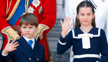 Prince Louis and Princess Charlotte wearing navy outfits and waving on Buckingham Palace's balcony