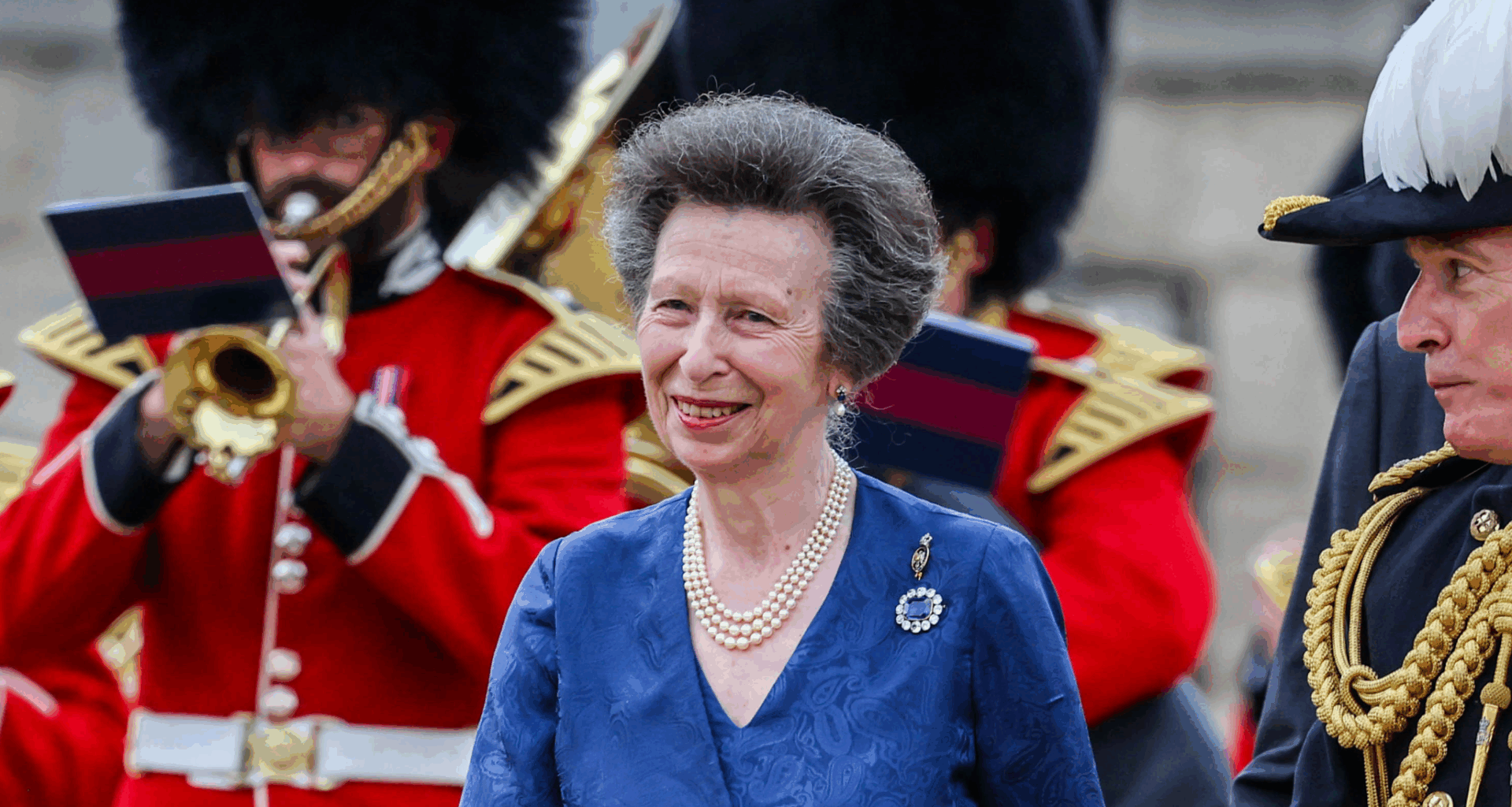 Princess Anne wears a pearl necklace and blue dress