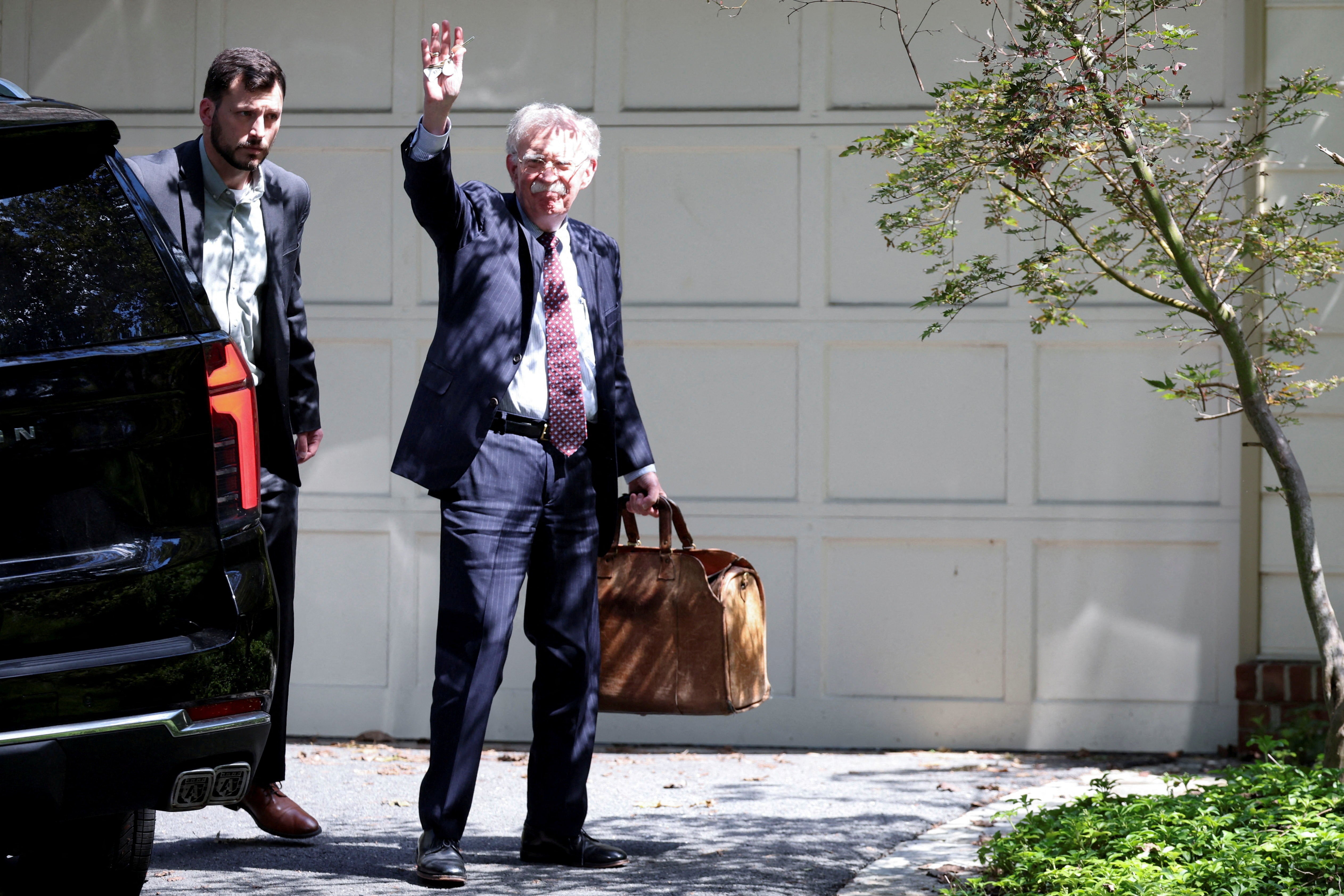 Former White House national security adviser John Bolton arrives at his house following its search by the FBI
