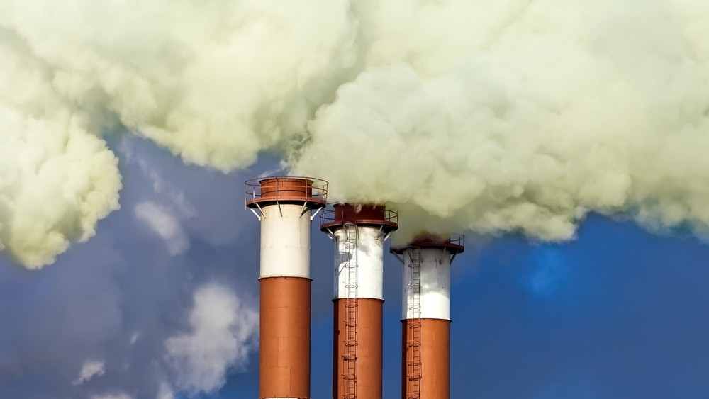 Smoke coming out of 3 chimneys.