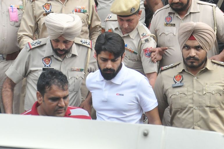 AMRITSAR, INDIA OCTOBER 31: Gangster Lawrence Bishnoi amid heavy police security while coming out of the Amritsar court complex on October 31, 2022 in Amritsar, India. Gangster Lawrence Bishnoi was brought on transit remand from Jalandhar by the Amritsar rural police before presenting him in a local court here. Bishnoi had been on a 10-day remand with the Jalandhar commissionerate police in a case pertaining to the sale and purchase of weapons. (Photos by Sameer Sehgal/Hindustan Times via Getty Images)