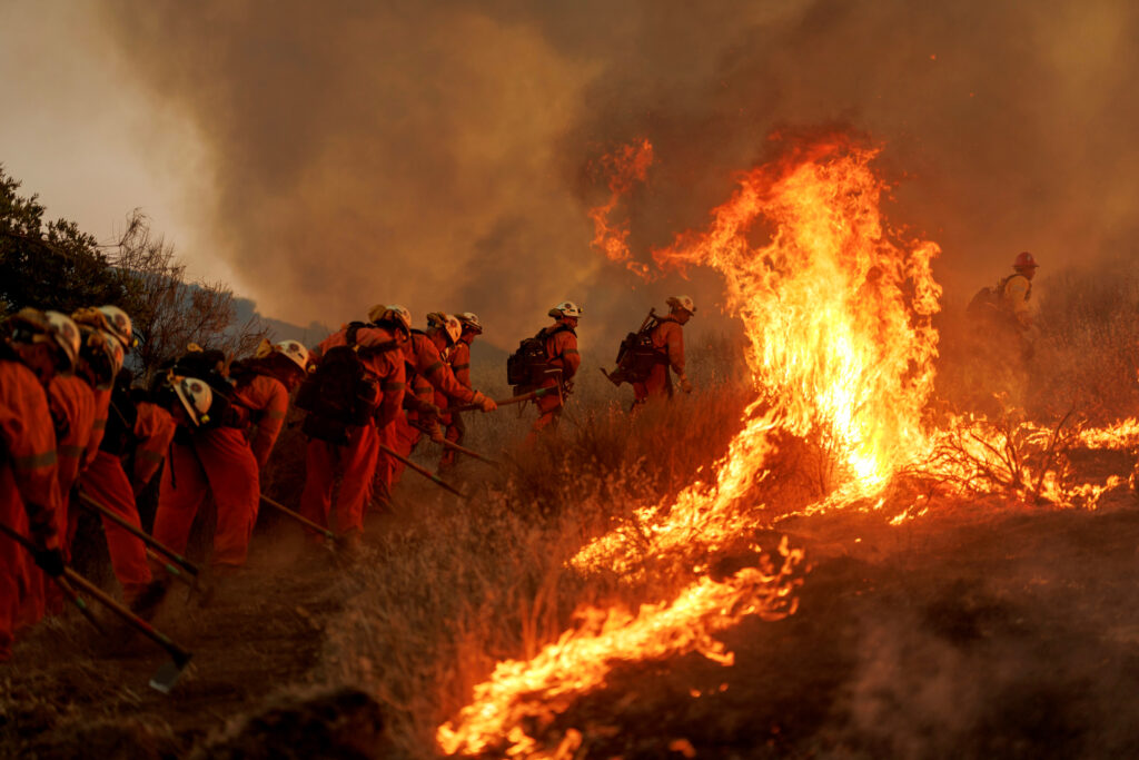 Firefighters battle flames from the Canyon Fire on Aug. 7 in Castaic, Calif. Credit: Eric Thayer/Getty Images
