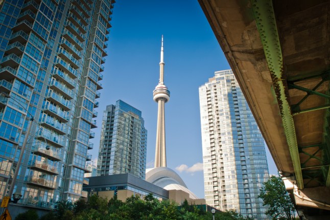 A view of the CN Tower from the ground in Toronto, Canada on a sunny day.