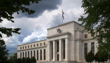 the federal reserve building in washington dc under gathering storm clouds
