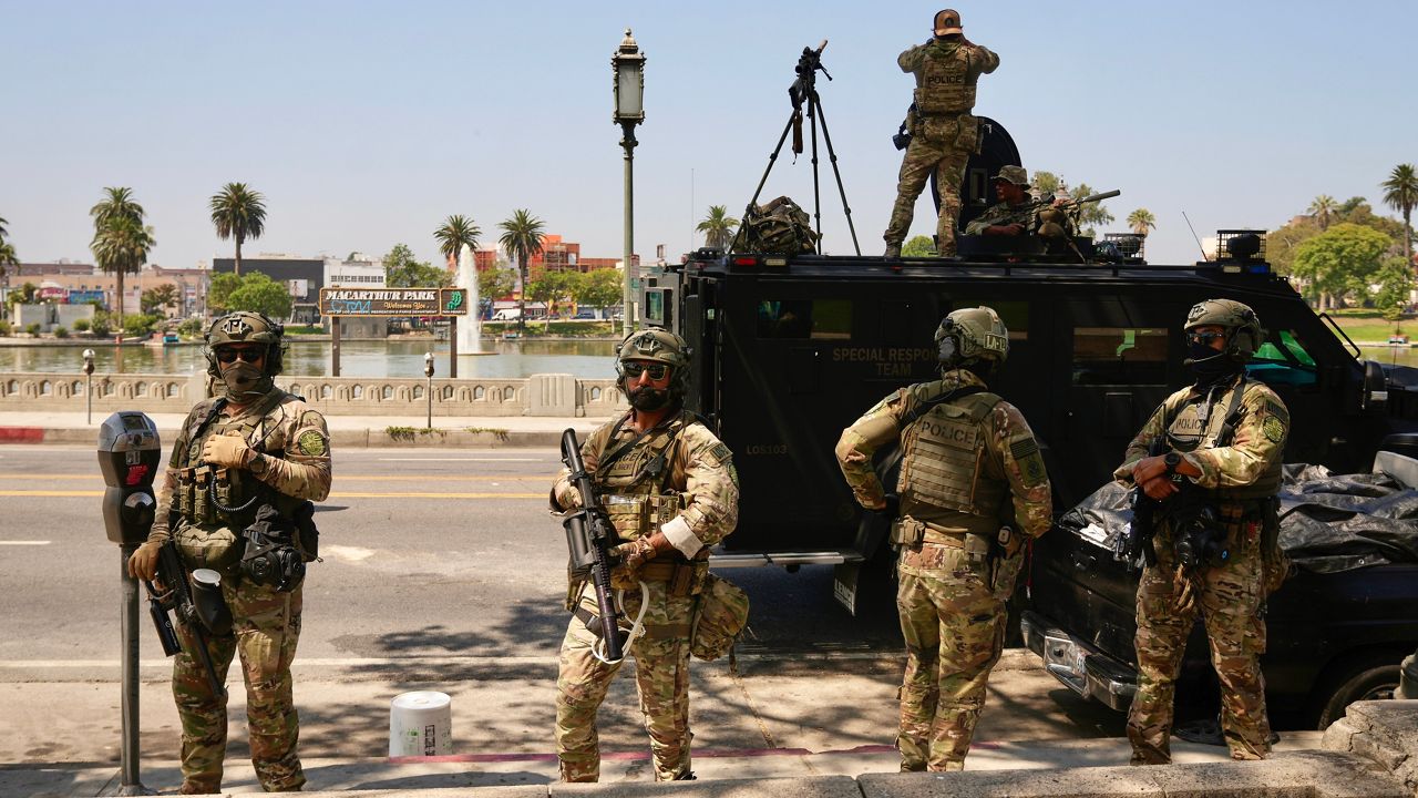 Federal agents stage at MacArthur Park Monday, July 7, 2025, in Los Angeles. (AP Photo/Damian Dovarganes)