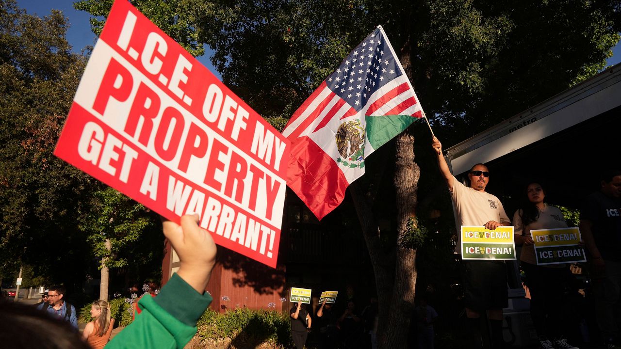 Residents gather during a community vigil on Monday, June 30, 2025, to stand in solidarity with an immigrant family after ICE agents detained Rosalina Luna Vargas on Saturday, June 28, in front of her children, in Pasadena, Calif. (AP Photo/Damian Dovarganes)