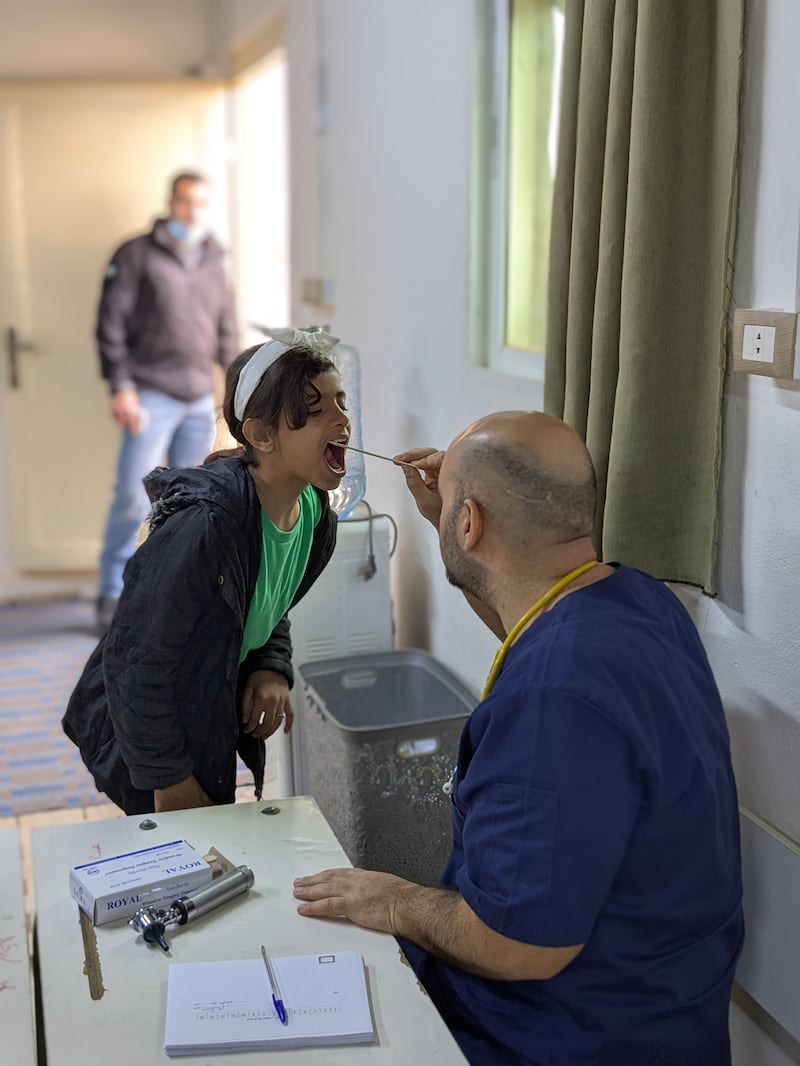 Refugee families receive care from the doctors at a monthly health clinic in the Mafraq settlement near Zarqa, Jordan, in 2025.