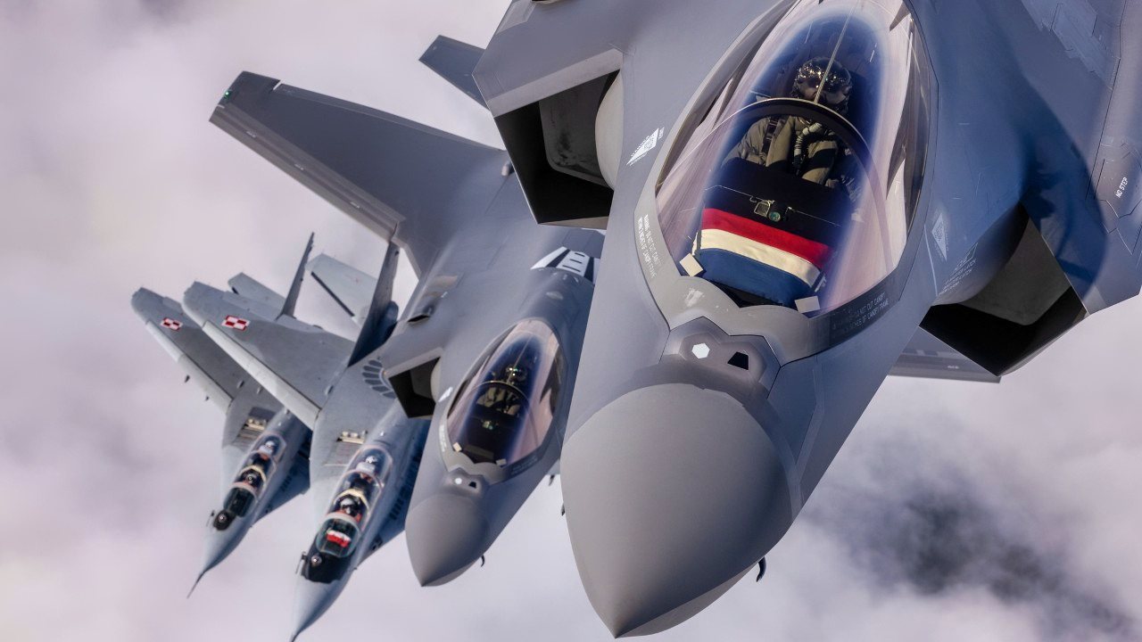 Royal Netherlands Air Force F-35 Lighting II fighters fly in formation with Polish Air Force MiG-29 Fulcrums during a training sortie over Poland on 21 March 2023.