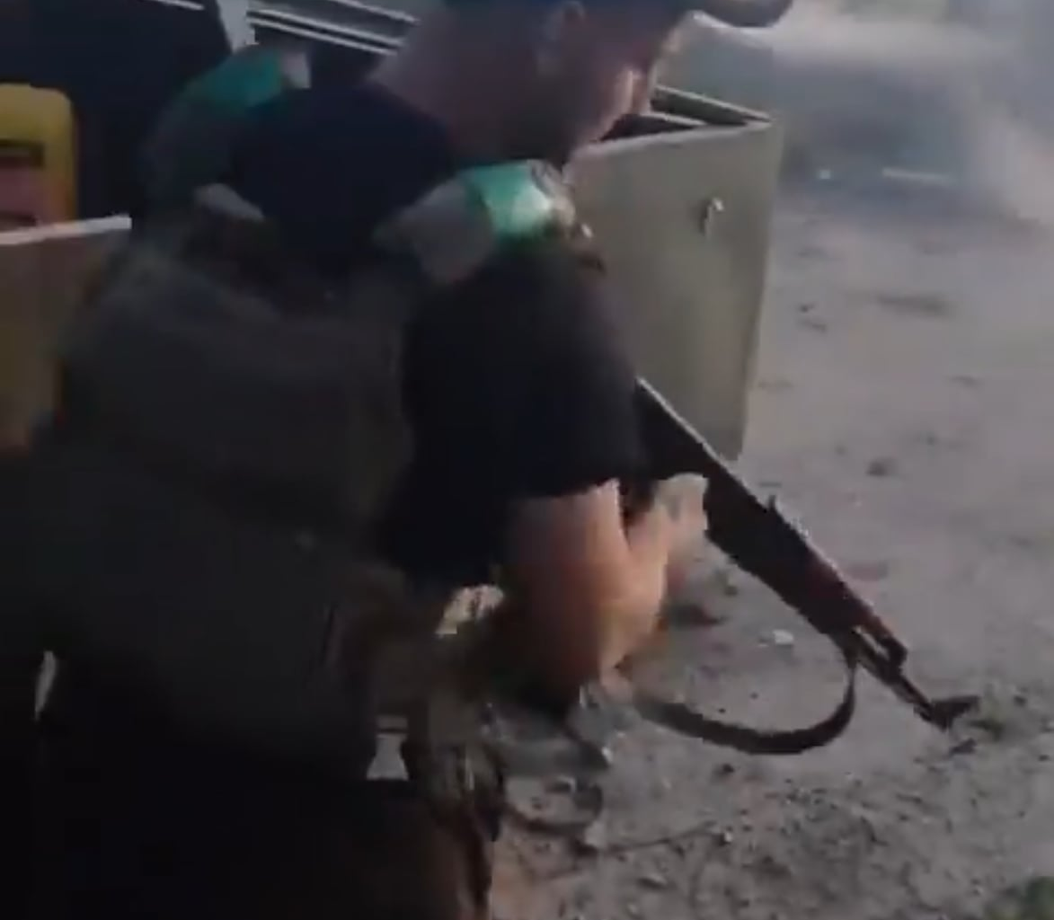 Ukrainian soldier of the 155th Mechanized Brigade shoots a Russian FPV drone laying on the ground in Pokrovsk. August 2025