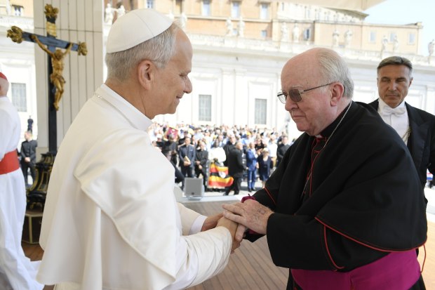 Bishop Kevin Vann of the Diocese of Orange is greeted...