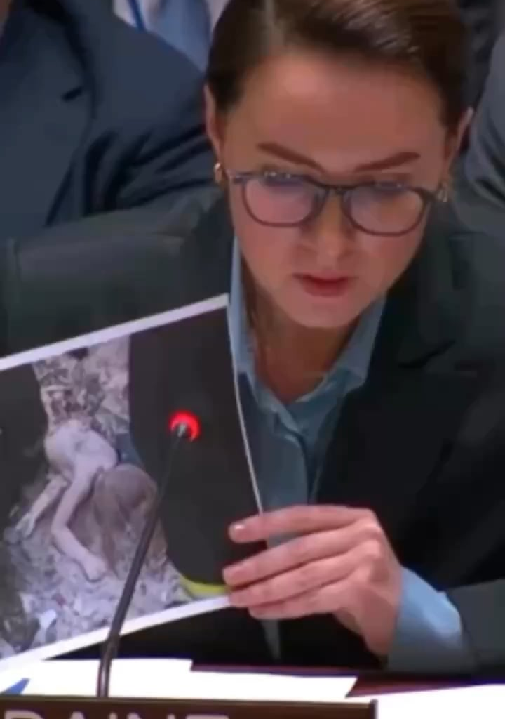 At the UN Security Council, Ukraine’s PM shows a photo of a child killed in Russia’s airstrike on Kyiv while the Russian delegate looks at her phone.