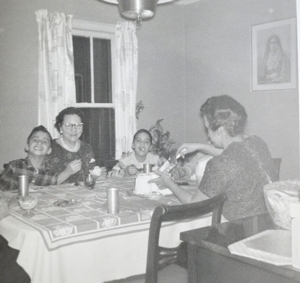 In this undated photo, Pope Leo XIV (then Robert Prevost) (left) smiles while his mother (back to the camera) cuts a birthday cake in what his brother (right) guessed was the pope