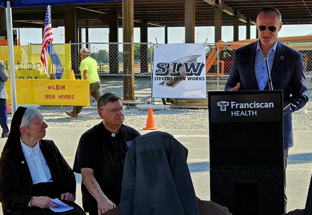 Franciscan Alliance Chairwoman of the Board of Trustees Sister M. Aline Shultz and Franciscan Health Crown Point Director of Spiritual Care Rev. Tony Janik listen as Dean and Barbara White Family Foundation Executive Director Bill Hanna speaks during the topping off ceremony Aug. 5 for The Dean and Barbara White Cancer Center. (Photo courtesy of Franciscan Health)