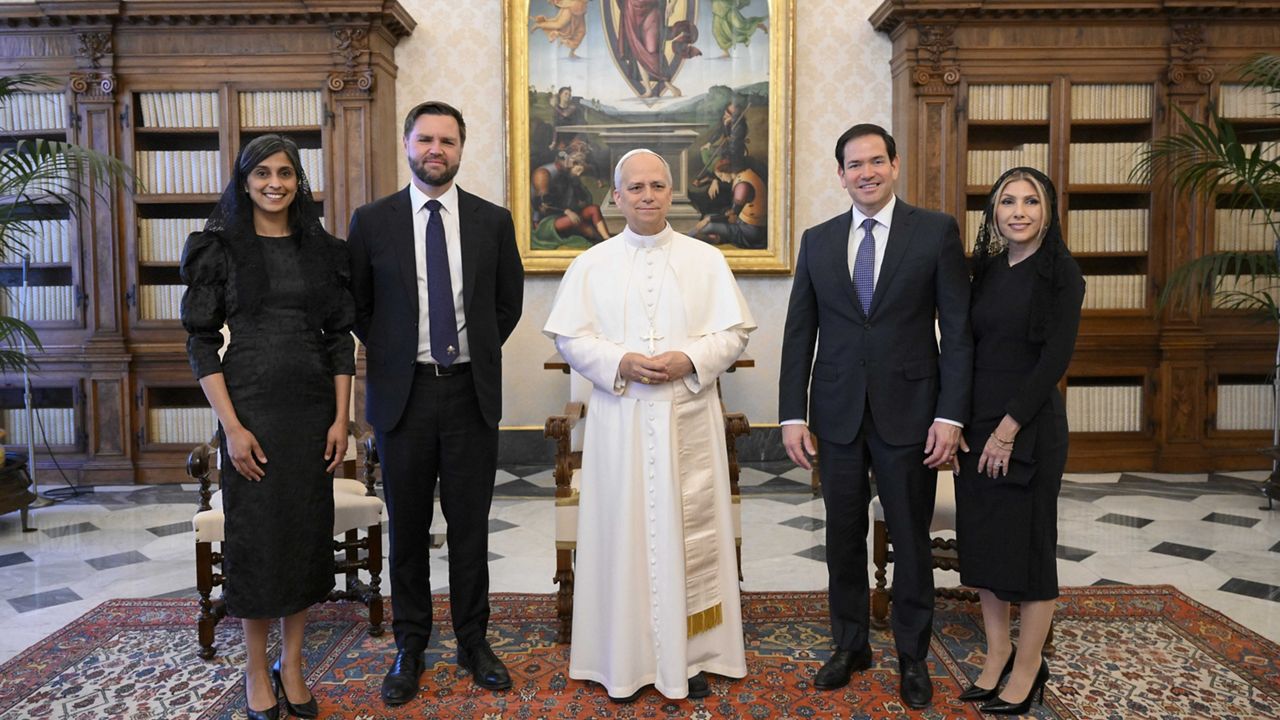 Pope Leo XIV stands for a family photo with Vice President JD Vance, second from left, his wife Usha Vance, Secretary of State Marco Rubio, second from right, and his wife Jeanette Dousdebes Rubio, on the occasion of their meeting at the Vatican, Monday, May 19, 2025. (Vatican Media via AP)