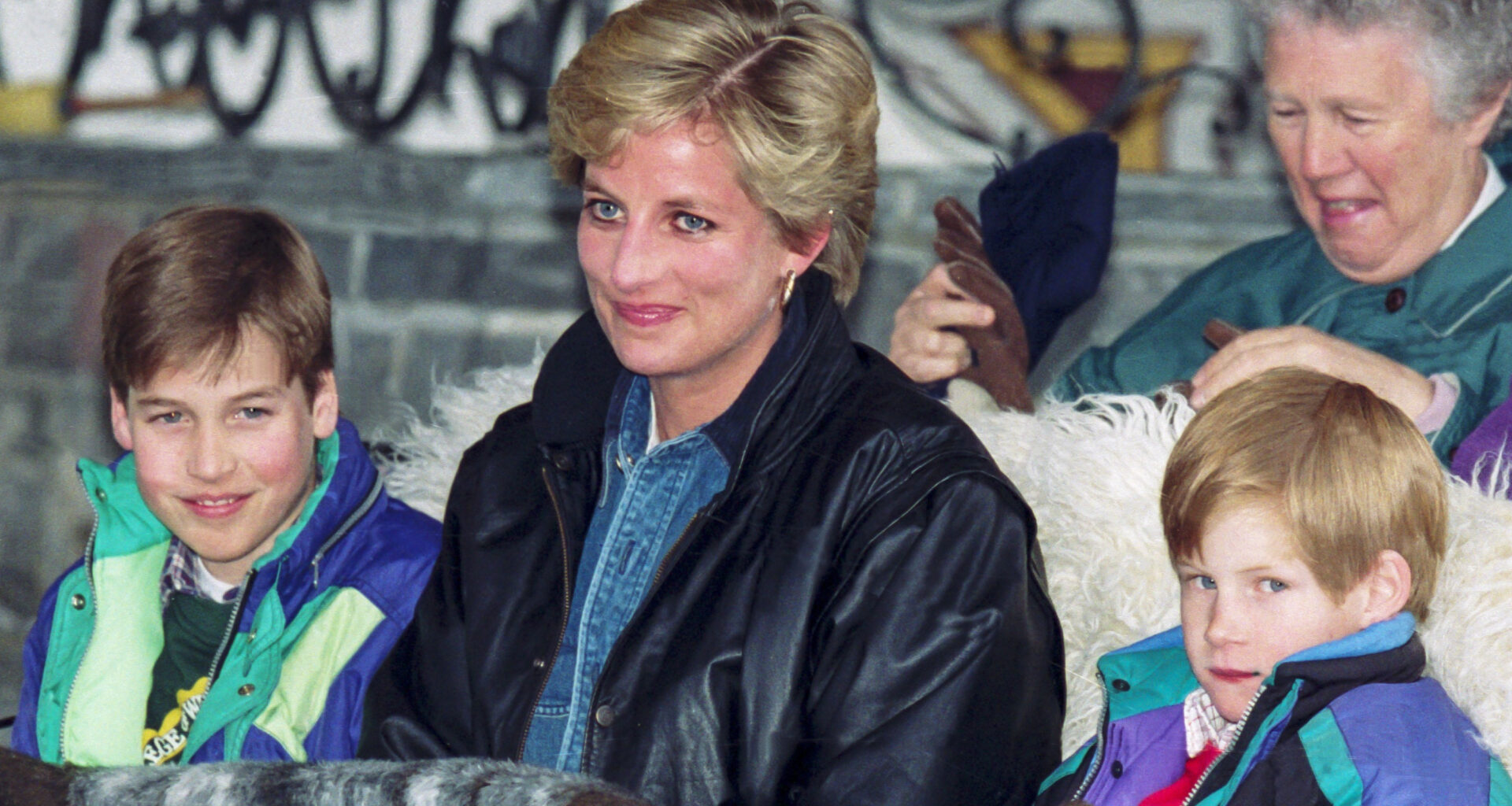 Prince William, Princess Diana, and Prince Harry ride in a sleigh