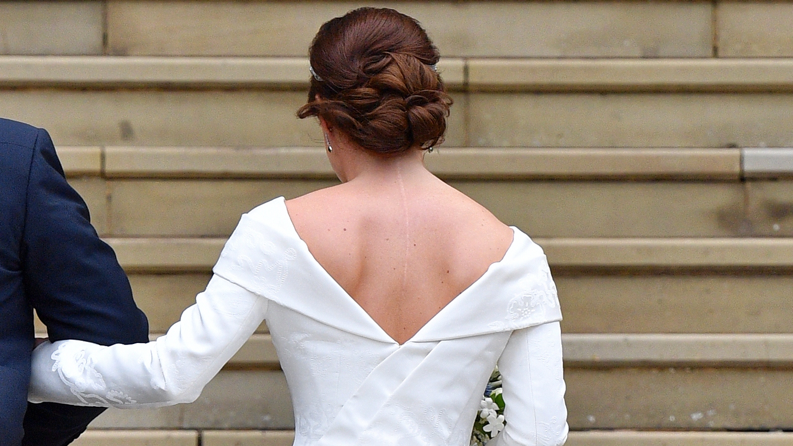Princess Eugenie (accompanied by her father Prince Andrew, Duke of York) outside St George's Chapel ahead of her wedding ceremony on October 12, 2018, photographed from behind