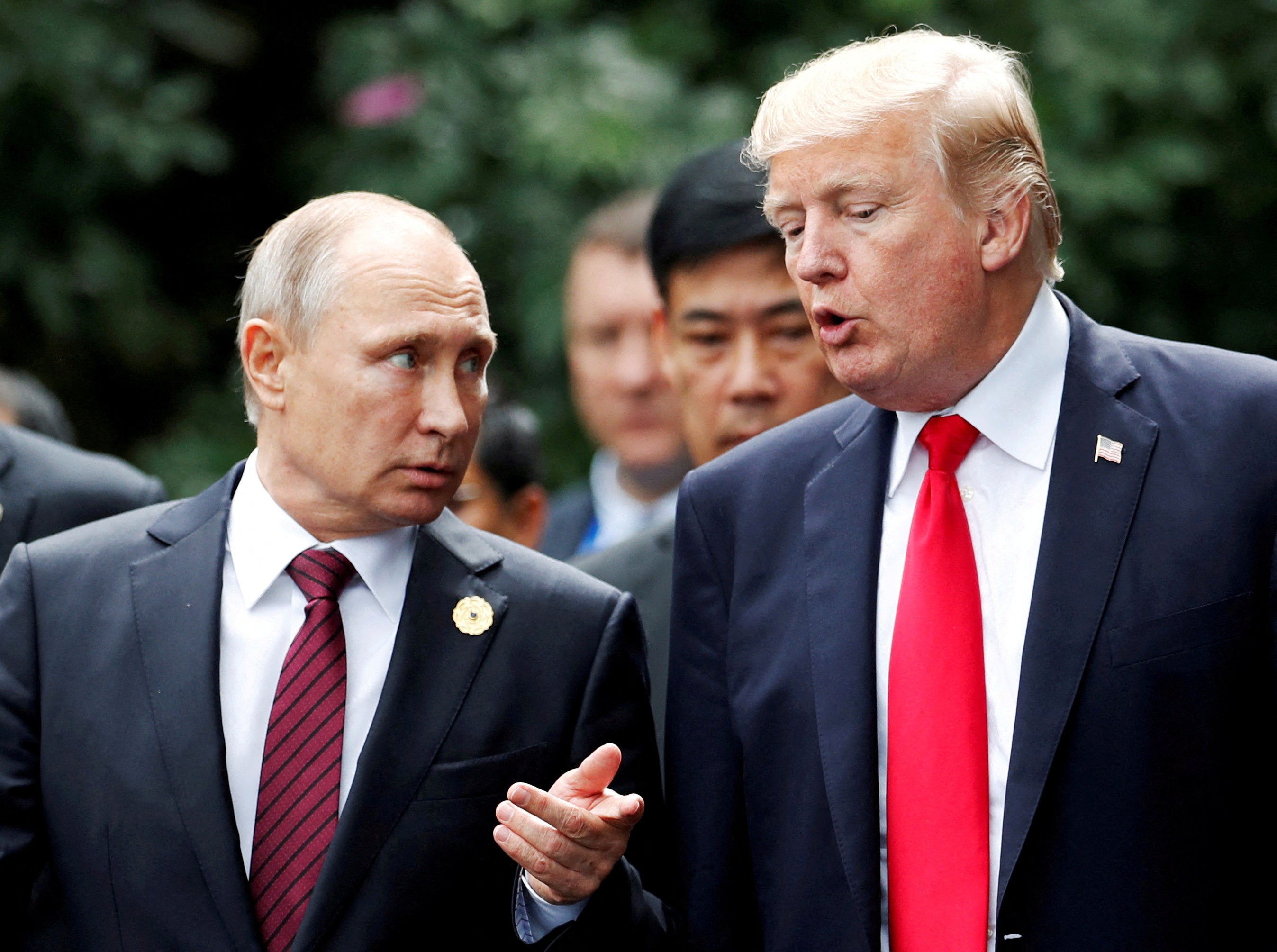 US pesident Donald Trump and Russia's president Vladimir Putin talk during the family photo session at the APEC Summit in Danang, Vietnam in 2017