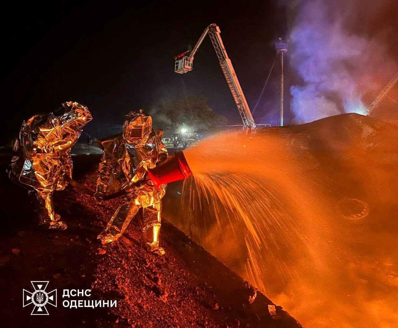 Firefighters work at the site of a fuel storage facility hit by a Russian drone strike, amid Russia's attack on Ukraine, in Odesa region