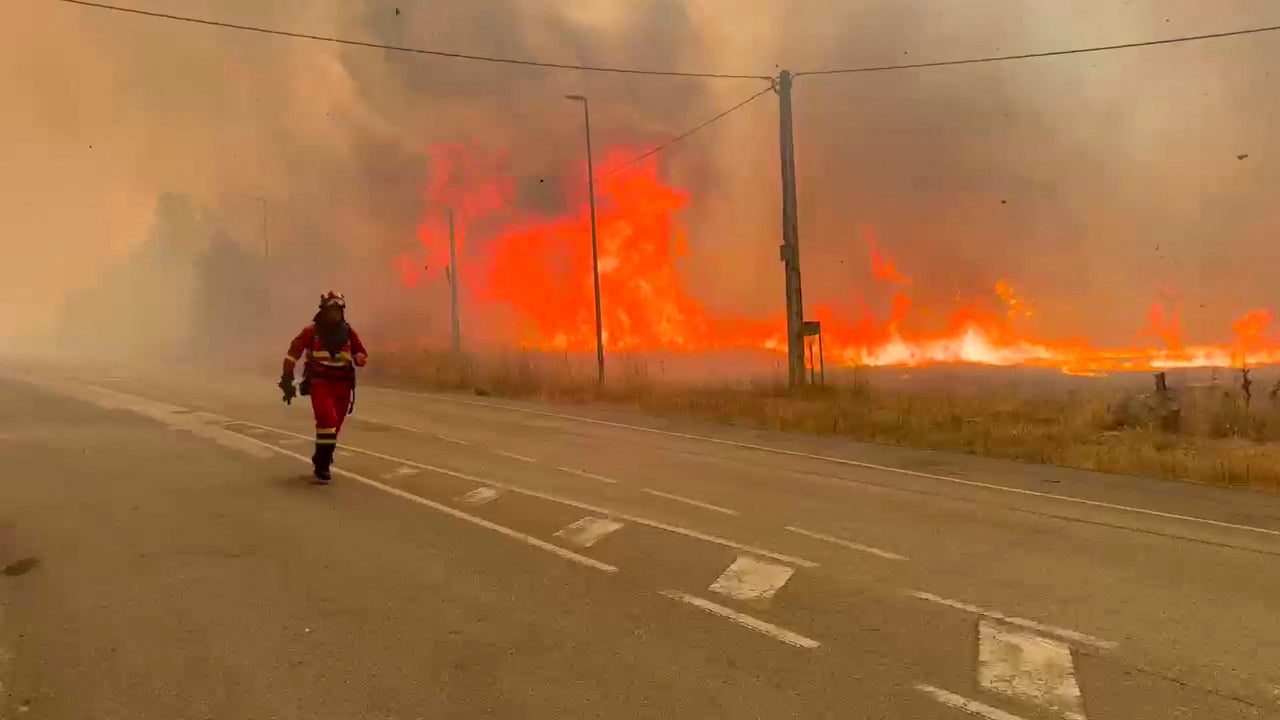 Military firefighters tackling a wildfire near Yeres, northwestern Spain