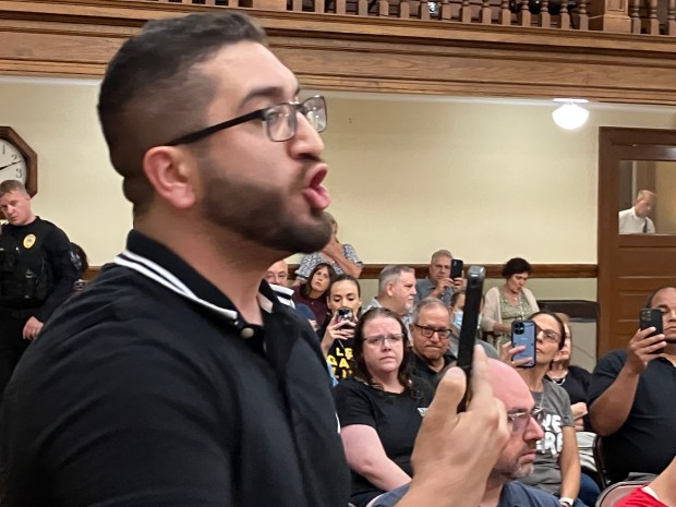 A pro-Palestianian protester addresses U.S. Rep. Sean Casten during a town hall meeting July 30, 2025, in La Grange. (Hank Beckman/for Pioneer Press)