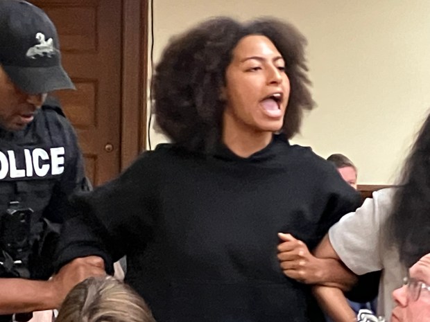 A protester continues to shout at U.S. Rep. Sean Casten while being forcibly removed from a town hall meeting July 30, 2025, in La Grange. (Hank Beckman/for Pioneer Press)