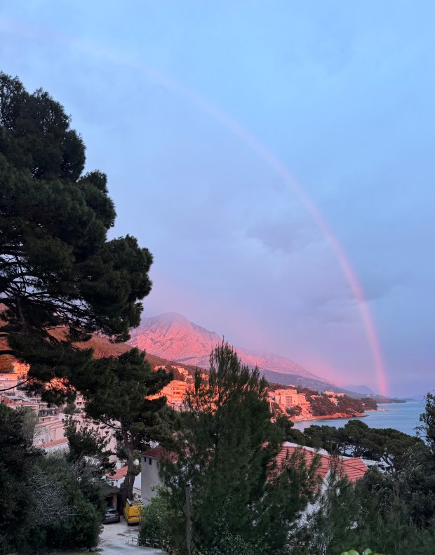 A rainbow across a blue sky.