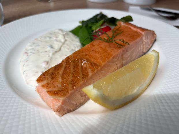 salmon, sauce and a lemon wedge