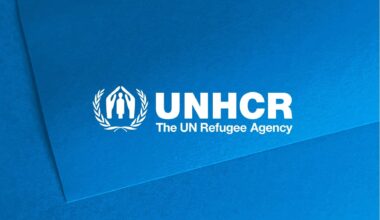 UNHCR logo in white over a light blue background