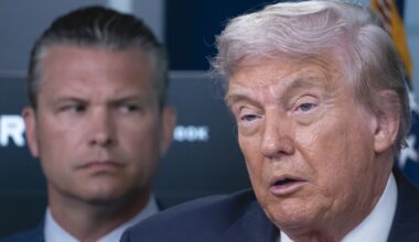 President Donald Trump speaks to reporters as Defense Secretary Pete Hegseth stands behind him