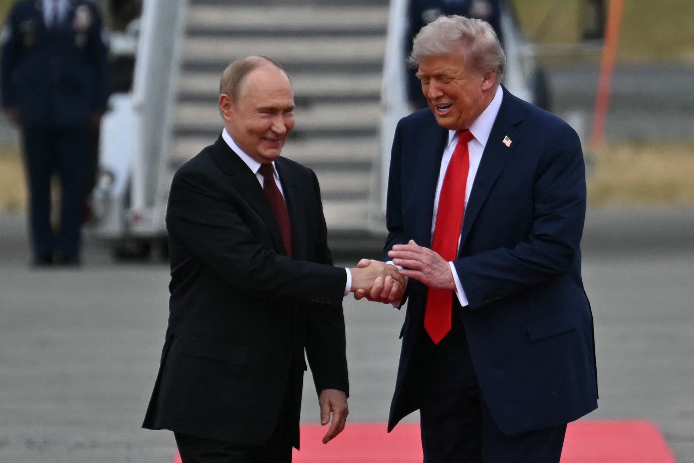 US President Donald Trump greets Russian President Vladimir Putin on the tarmac after they arrived at Joint Base Elmendorf-Richardson in Anchorage, Alaska, on August 15